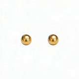A pair of Ball Stud Earrings 4mm by Skōsh Jewelry, featuring smooth, highly polished round gold balls on post backs, displayed against a white background.