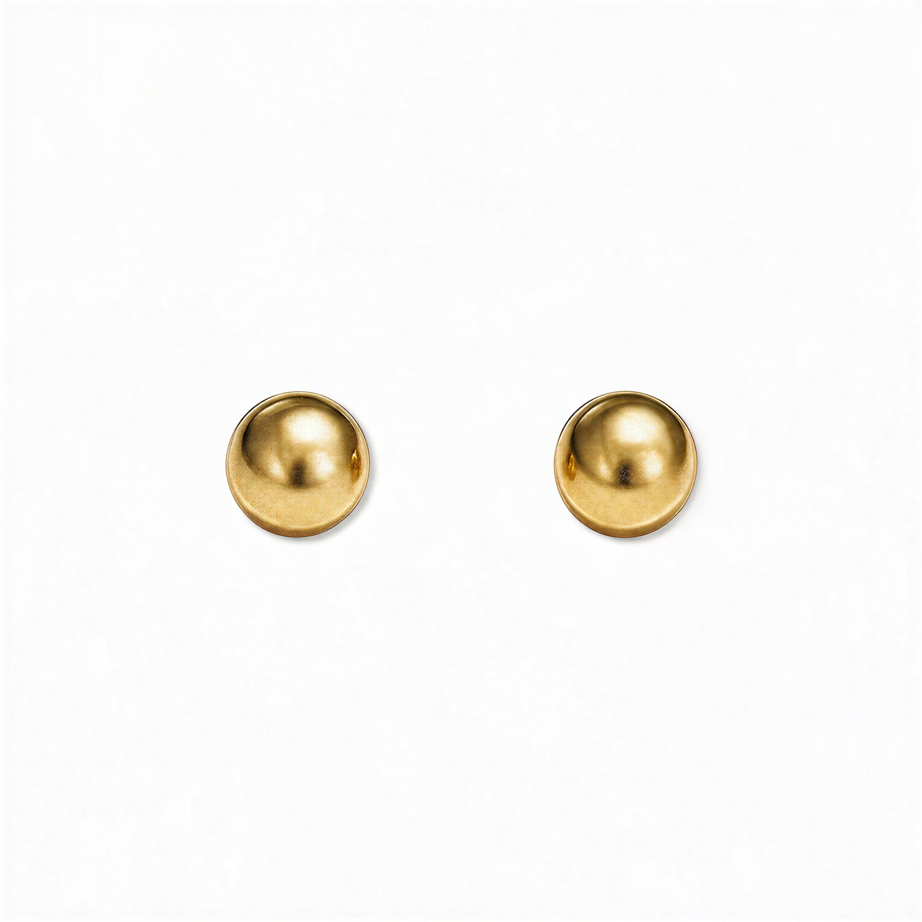 A pair of Ball Stud Earrings 6mm by Skōsh Jewelry, featuring smooth, highly polished round gold balls on post backs, displayed against a white background.