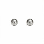 A pair of Ball Stud Earrings 6mm by Skōsh Jewelry, featuring smooth, highly polished round sterling silver balls on post backs, displayed against a white background.