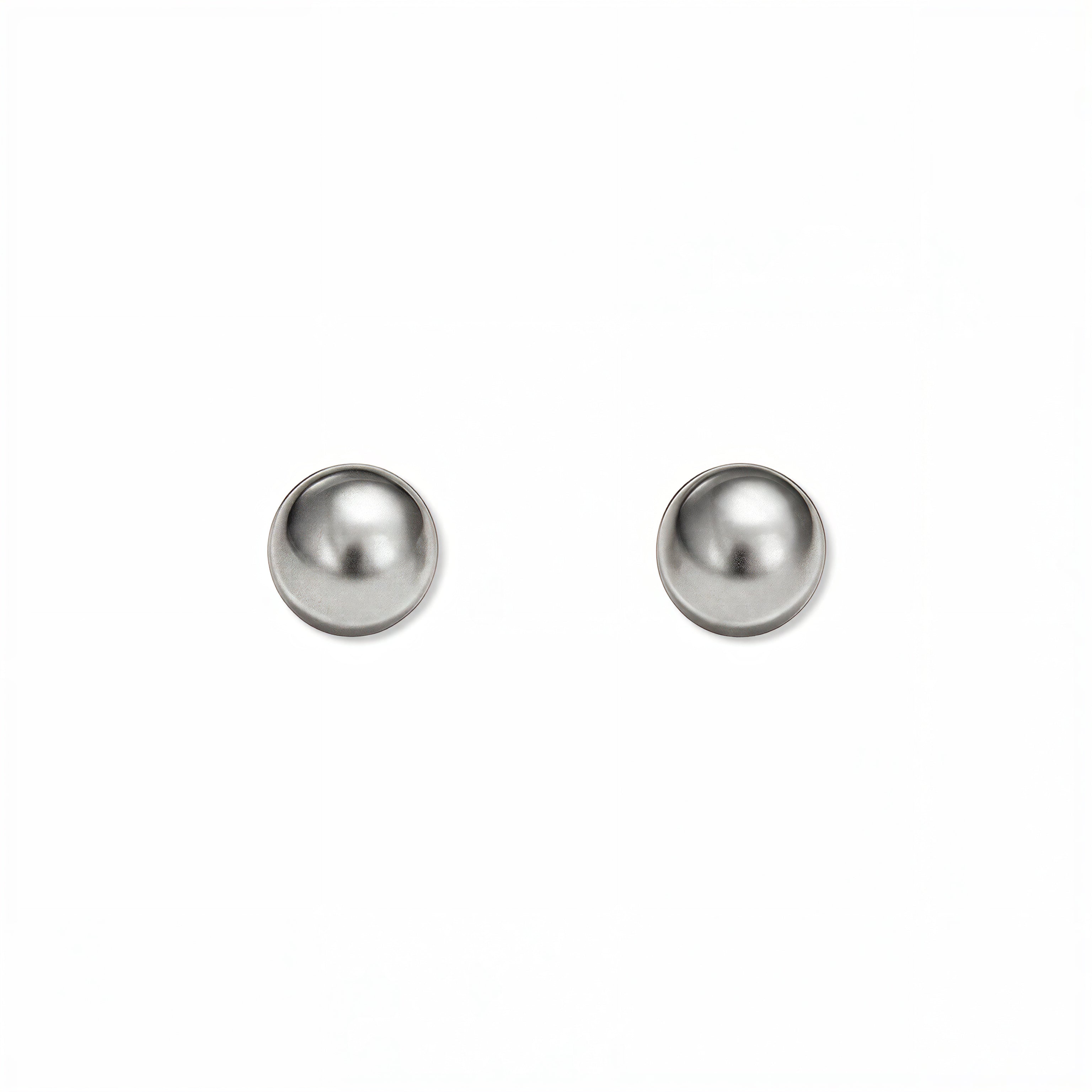 A pair of Ball Stud Earrings 6mm by Skōsh Jewelry, featuring smooth, highly polished round sterling silver balls on post backs, displayed against a white background.