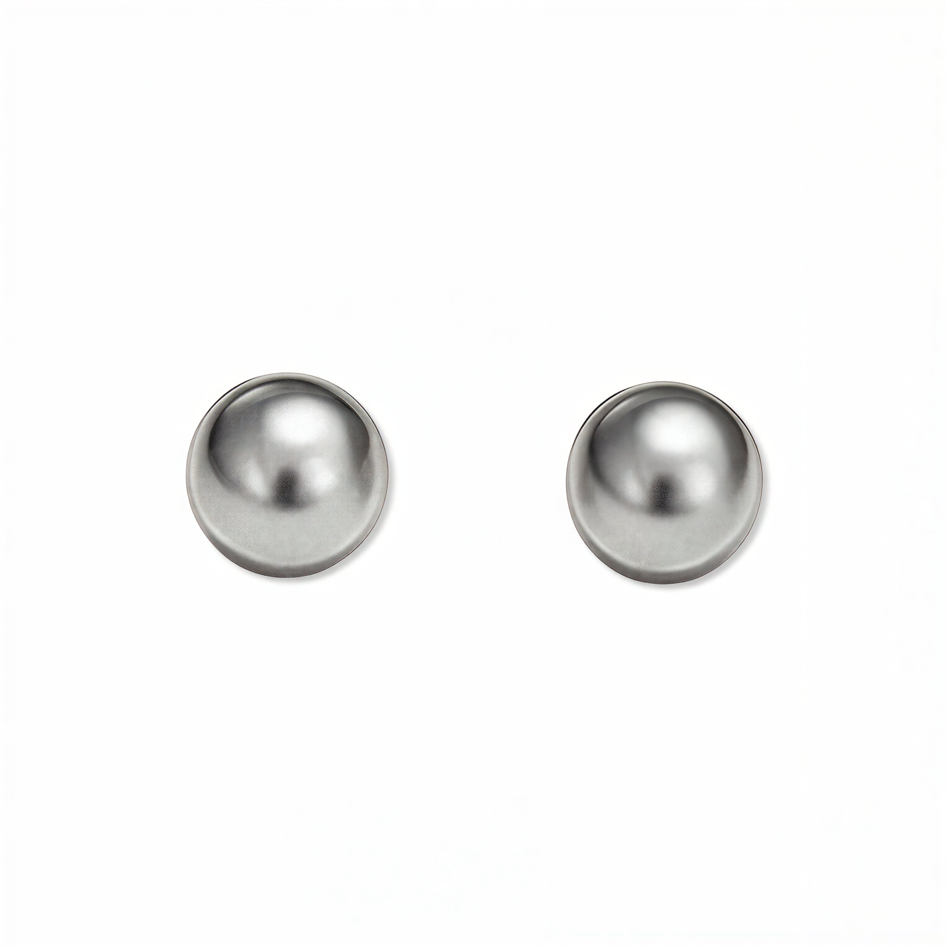 A pair of Ball Stud Earrings 8mm by Skōsh Jewelry, featuring smooth, highly polished round sterling silver balls on post backs, displayed against a white background.