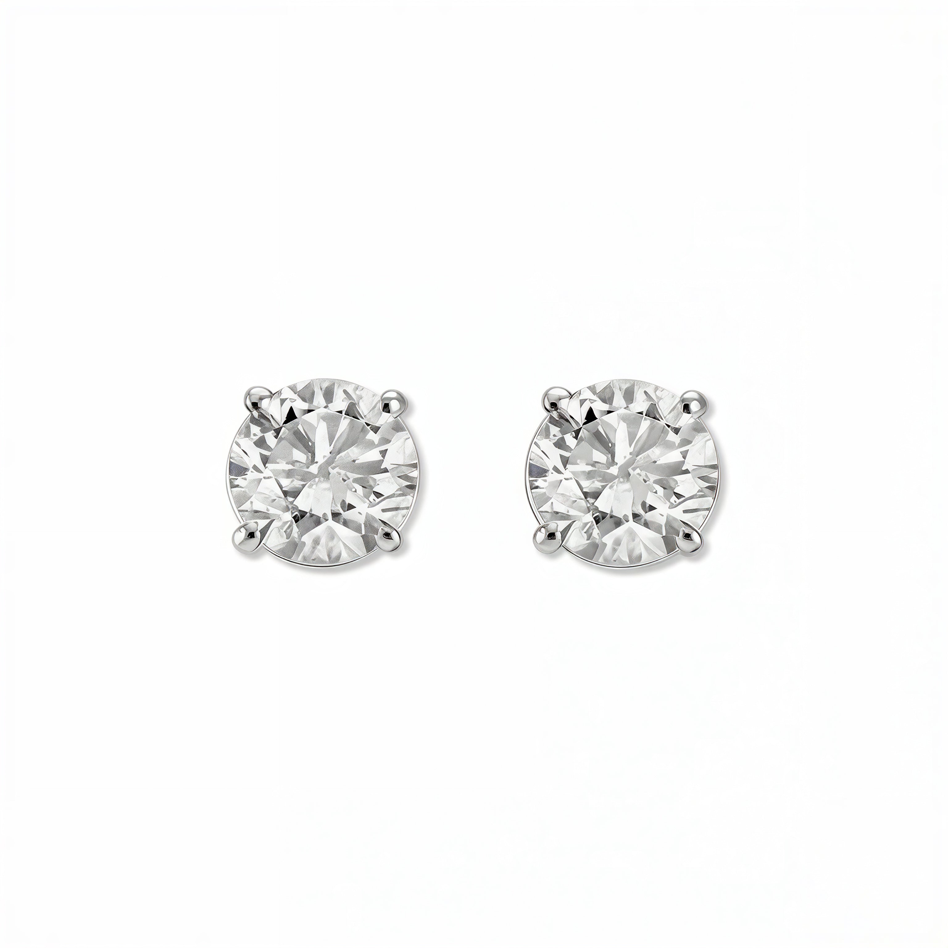 A pair of Round White Cubic Zirconia Stud Earrings 10mm by Skōsh Jewelry, featuring round, faceted clear stones in a four-prong sterling silver setting, displayed against a white background.