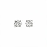 A pair of Round White Cubic Zirconia Stud Earrings 6mm by Skōsh Jewelry, featuring round, faceted clear stones in a four-prong sterling silver setting, displayed against a white background.