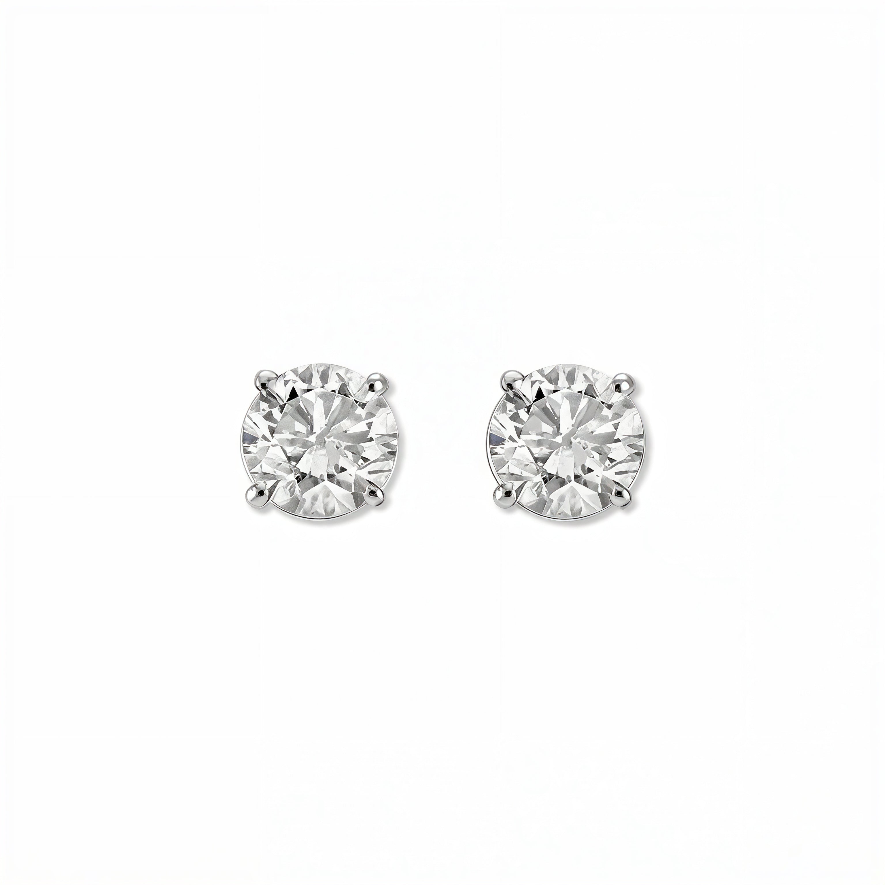 A pair of Round White Cubic Zirconia Stud Earrings 8mm by Skōsh Jewelry, featuring round, faceted clear stones in a four-prong sterling silver setting, displayed against a white background.
