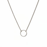 An Infinity Circle Necklace by Skōsh Jewelry, featuring a single open circle pendant attached at both sides to a delicate sterling silver cable chain, displayed against a white background.