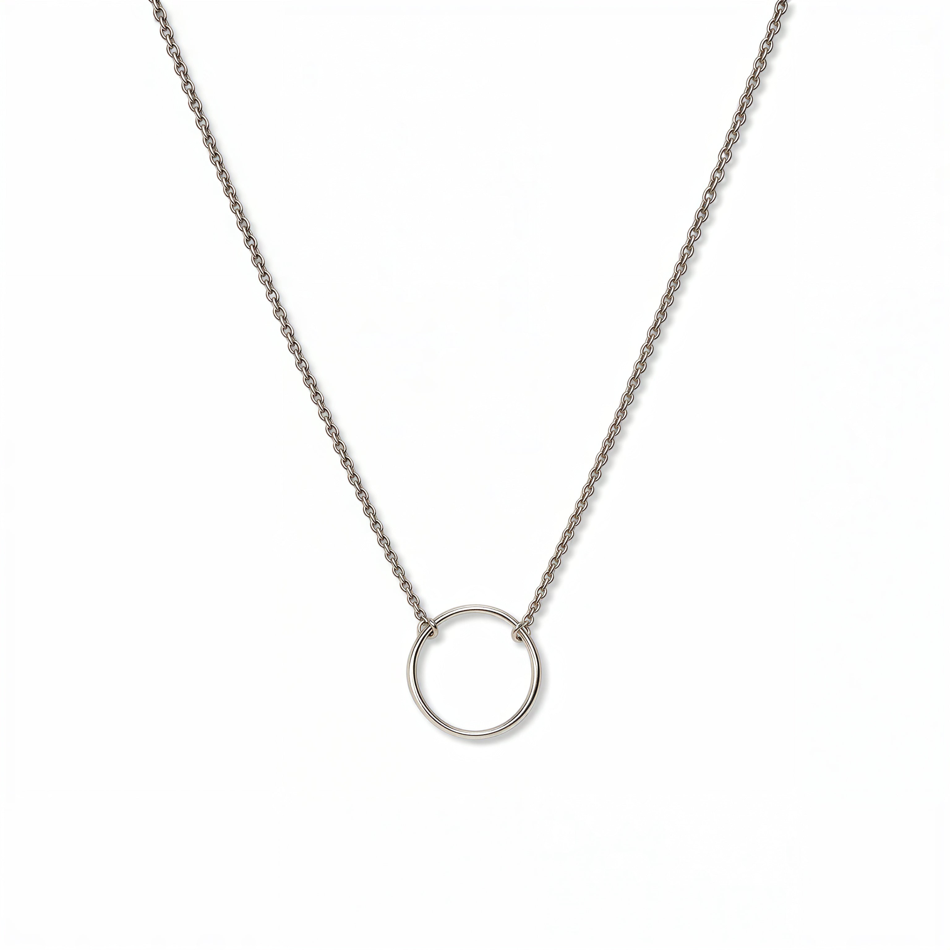An Infinity Circle Necklace by Skōsh Jewelry, featuring a single open circle pendant attached at both sides to a delicate sterling silver cable chain, displayed against a white background.
