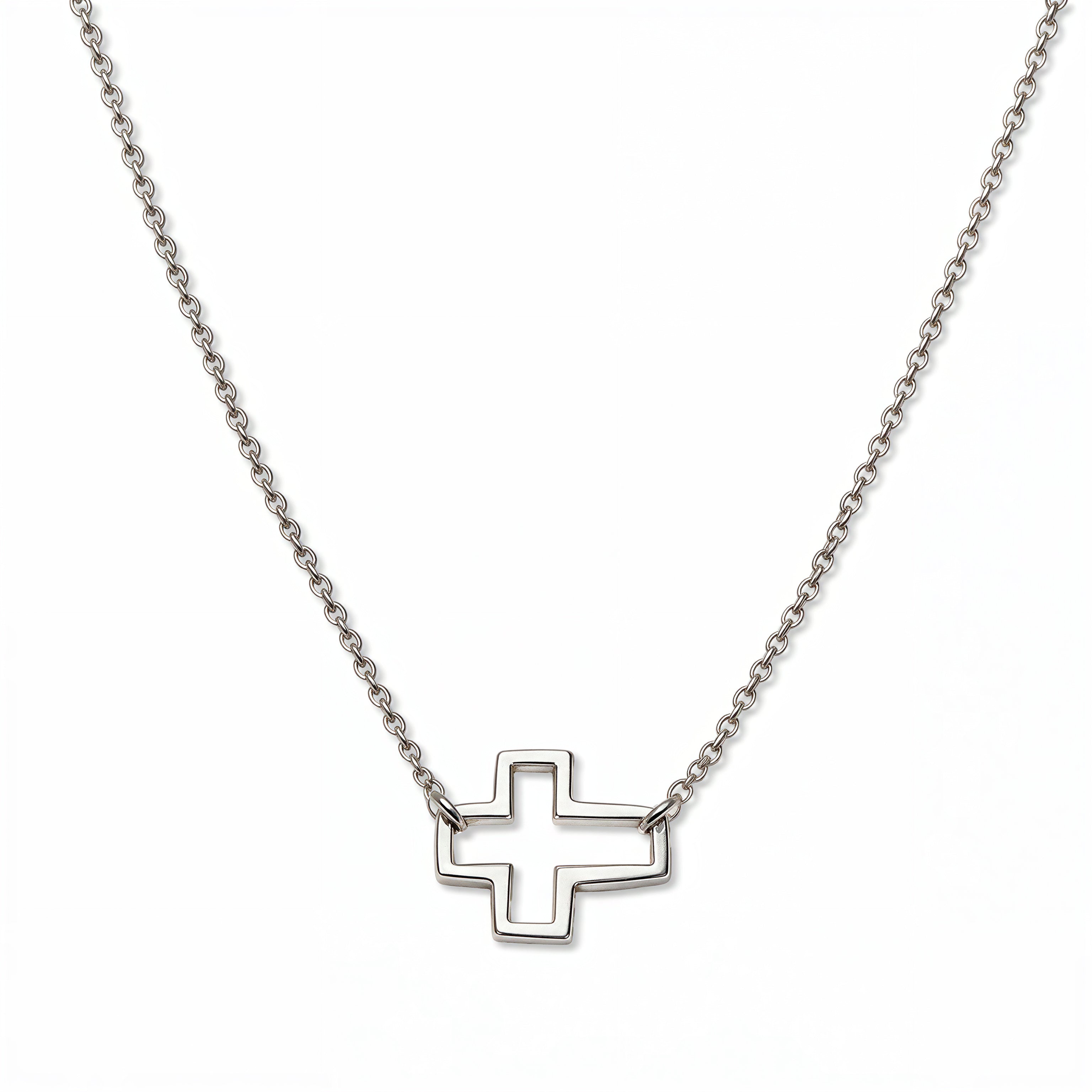 A Renewal Cutout Sideways Cross Necklace by Skōsh Jewelry, featuring an open cutout cross set sideways on a delicate sterling silver chain, displayed against a white background.