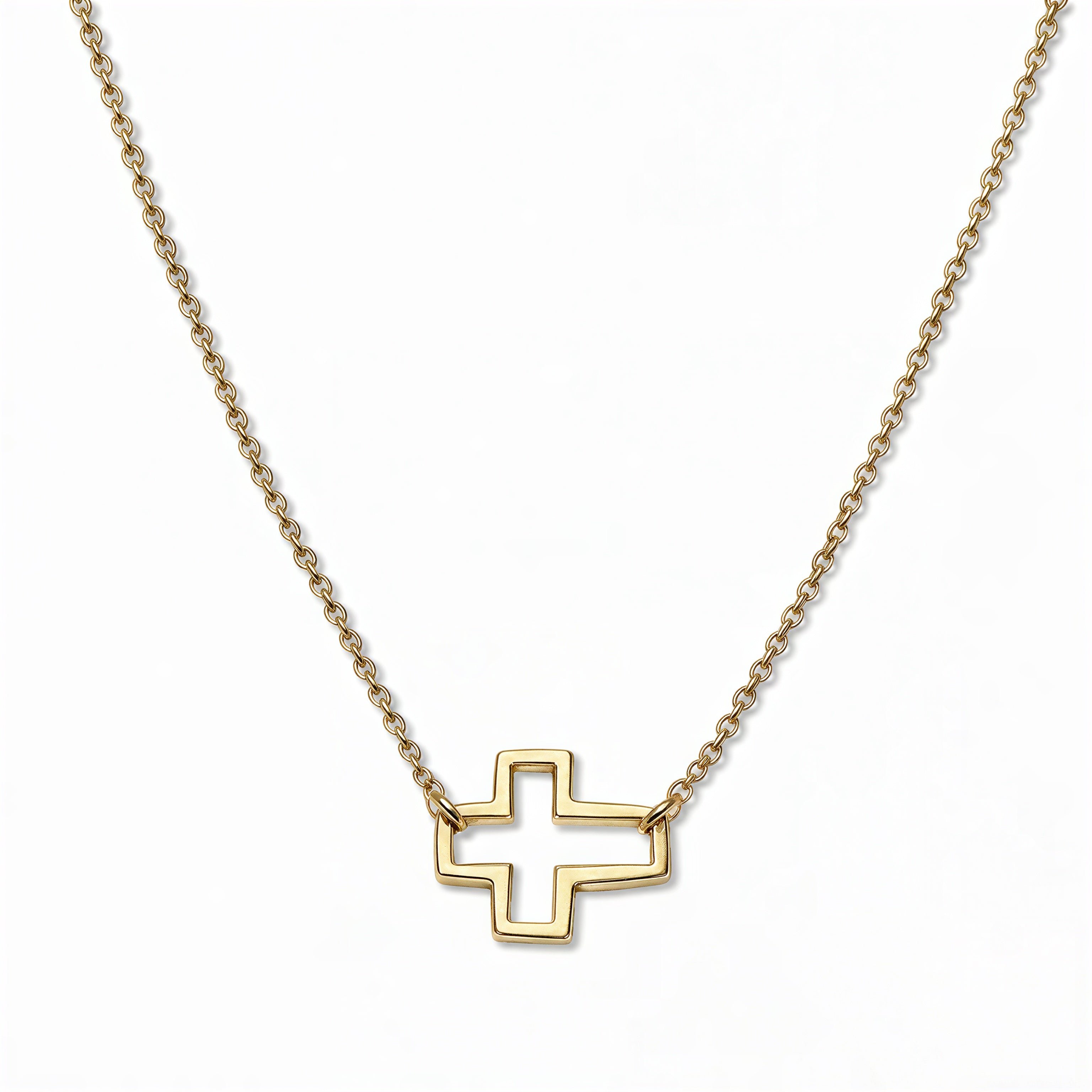 A Renewal Cutout Sideways Cross Necklace by Skōsh Jewelry, featuring an open cutout cross set sideways on a delicate gold chain, displayed against a white background.