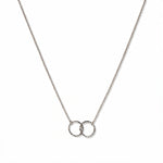 A Friendship Interlocking Circles Necklace by Skōsh Jewelry, featuring two small interlocking circles of equal size on a fine sterling silver chain, displayed against a white background.