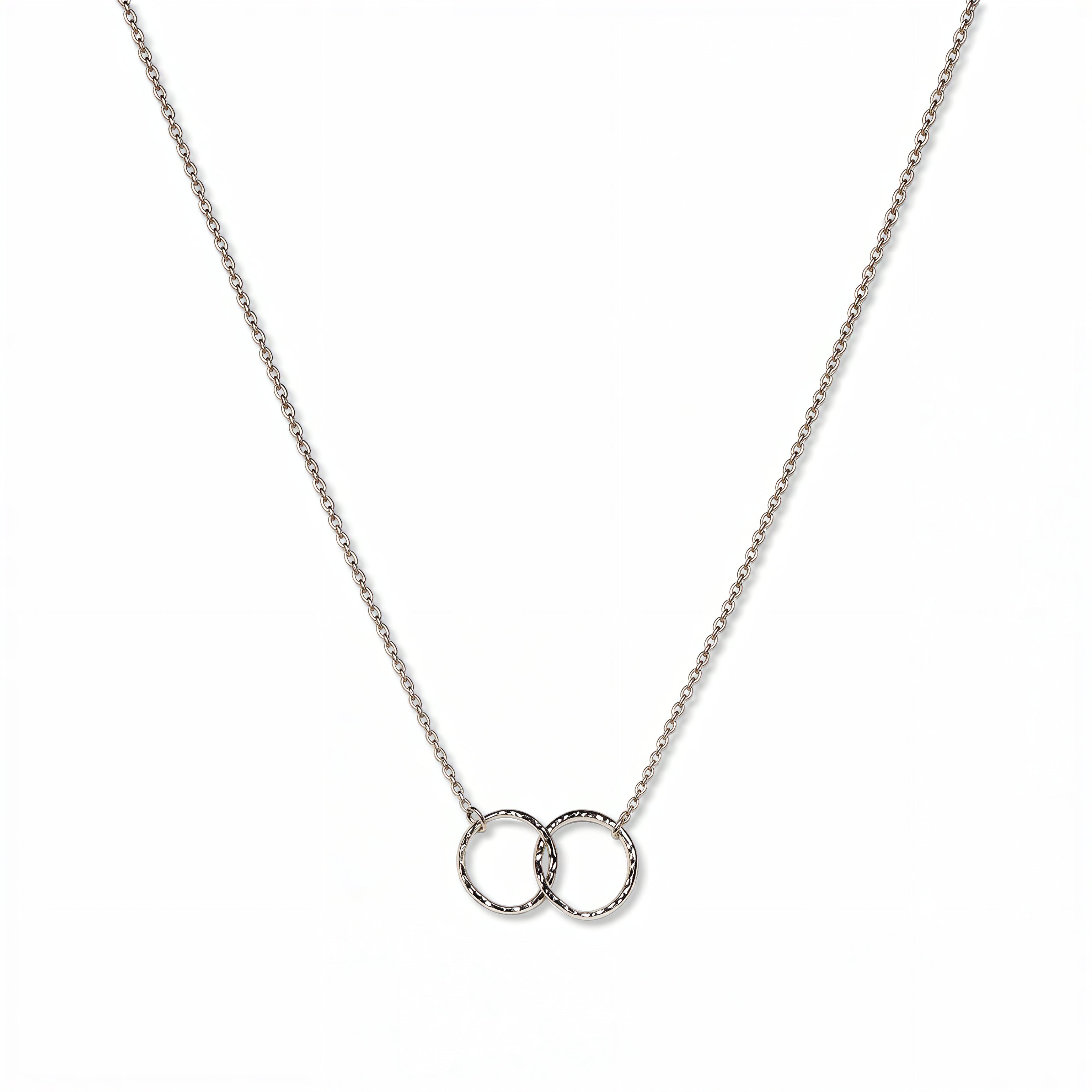 A Friendship Interlocking Circles Necklace by Skōsh Jewelry, featuring two small interlocking circles of equal size on a fine sterling silver chain, displayed against a white background.