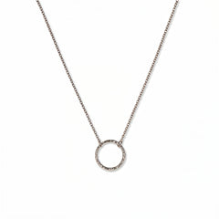 An Aura Hammered Circle Necklace by Skōsh Jewelry, featuring an open circle with a hammered, textured finish on a fine sterling silver chain, displayed against a white background.