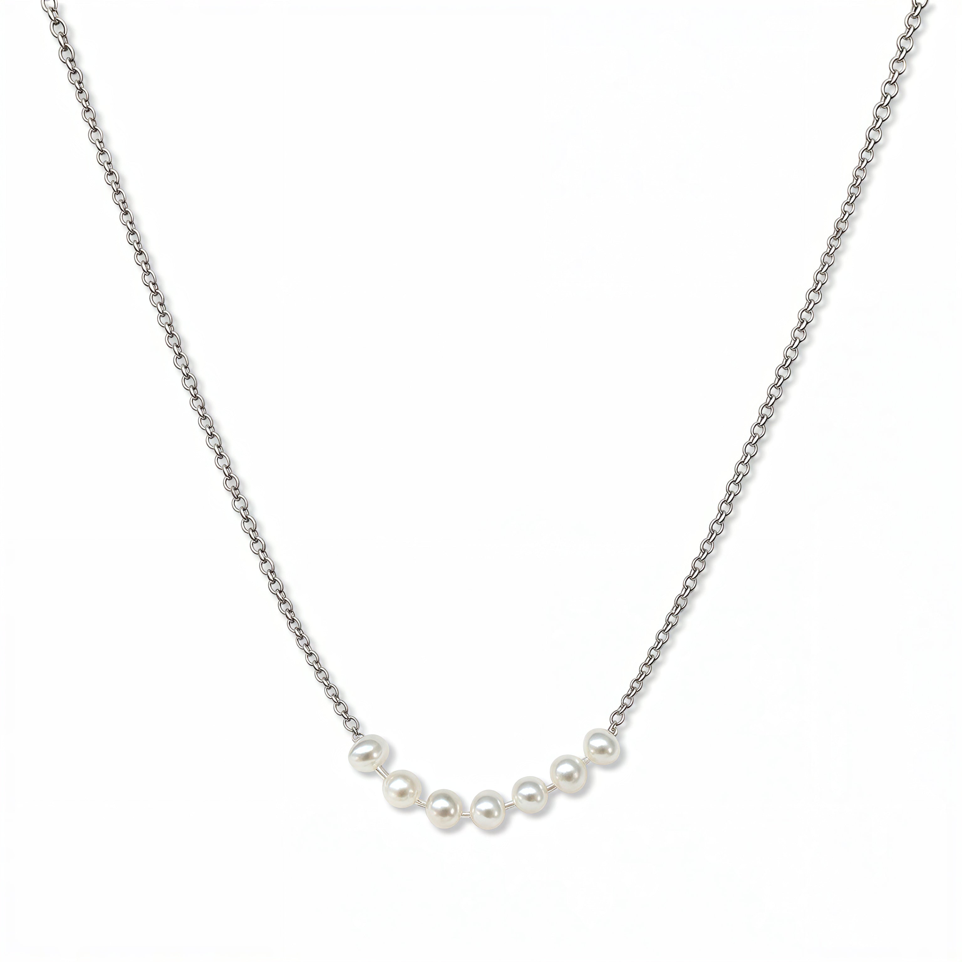 A Skōsh Kids Seven Freshwater Pearl Daily Prayer Necklace by Skōsh Jewelry, featuring a row of seven small white freshwater pearls along a fine sterling silver chain, displayed against a white background.