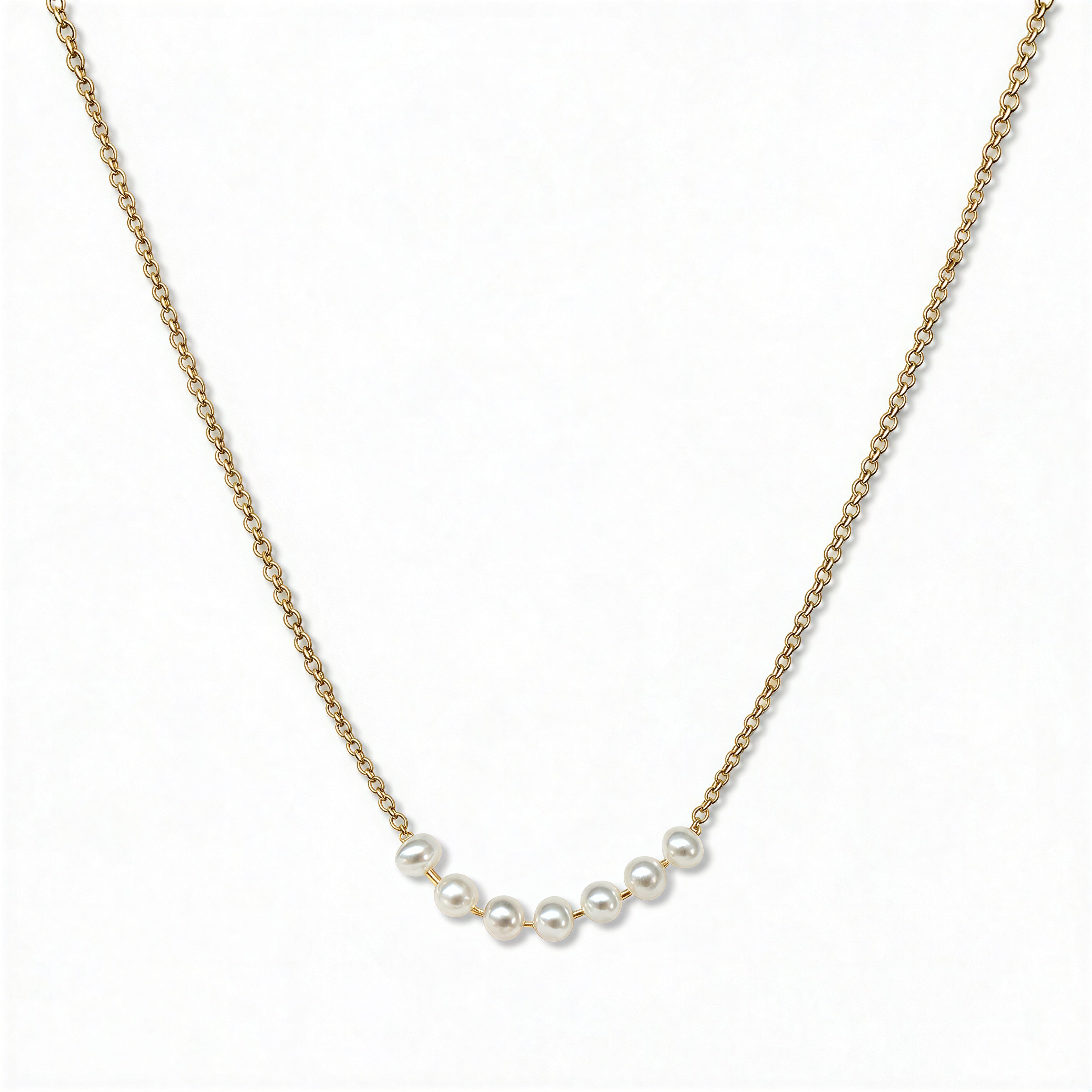 A Skōsh Kids Seven Freshwater Pearl Daily Prayer Necklace by Skōsh Jewelry, featuring a row of seven small white freshwater pearls along a fine gold chain, displayed against a white background.