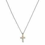 A Skōsh Kids Freshwater Pearl Cross Pendant Necklace by Skōsh Jewelry, featuring a small cross pendant made of tiny white pearl beads hanging from a fine sterling silver chain, displayed against a white background.