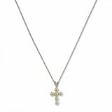 A Skōsh Kids Freshwater Pearl Cross Pendant Necklace by Skōsh Jewelry, featuring a small cross pendant made of tiny white pearl beads hanging from a fine sterling silver chain, displayed against a white background.