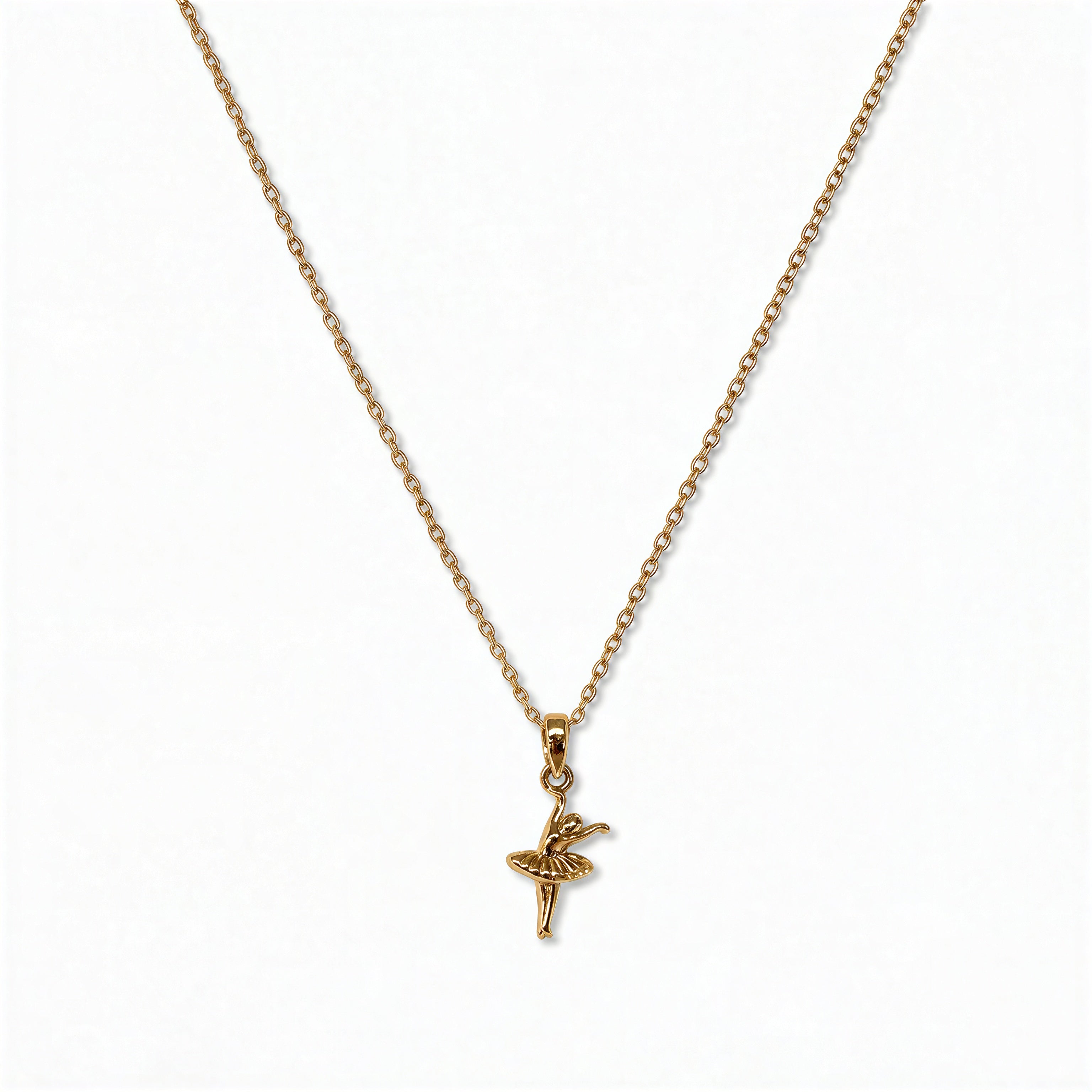 A Skōsh Kids Ballerina Pendant Necklace by Skōsh Jewelry, featuring a small ballerina figure pendant posed mid-dance on a fine gold chain, displayed against a white background.