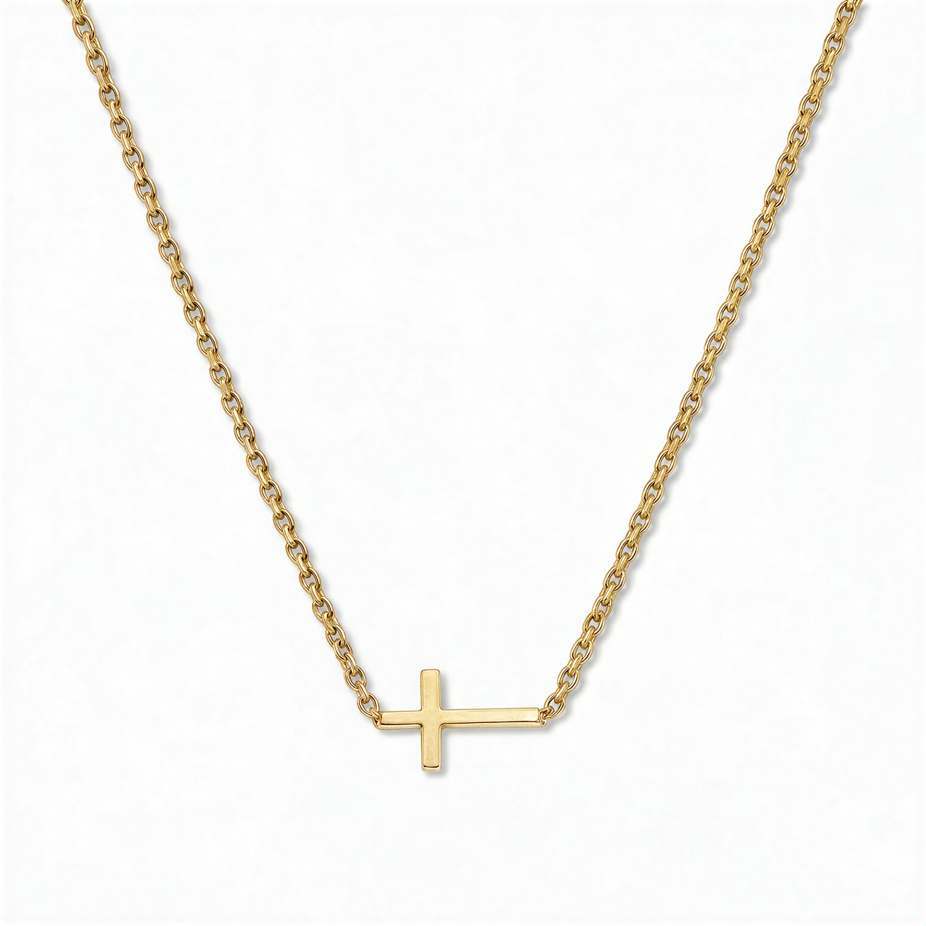 A Skōsh Kids Inline Sideways Cross Necklace by Skōsh Jewelry, featuring a slim polished cross set sideways on a fine gold chain, displayed against a white background.