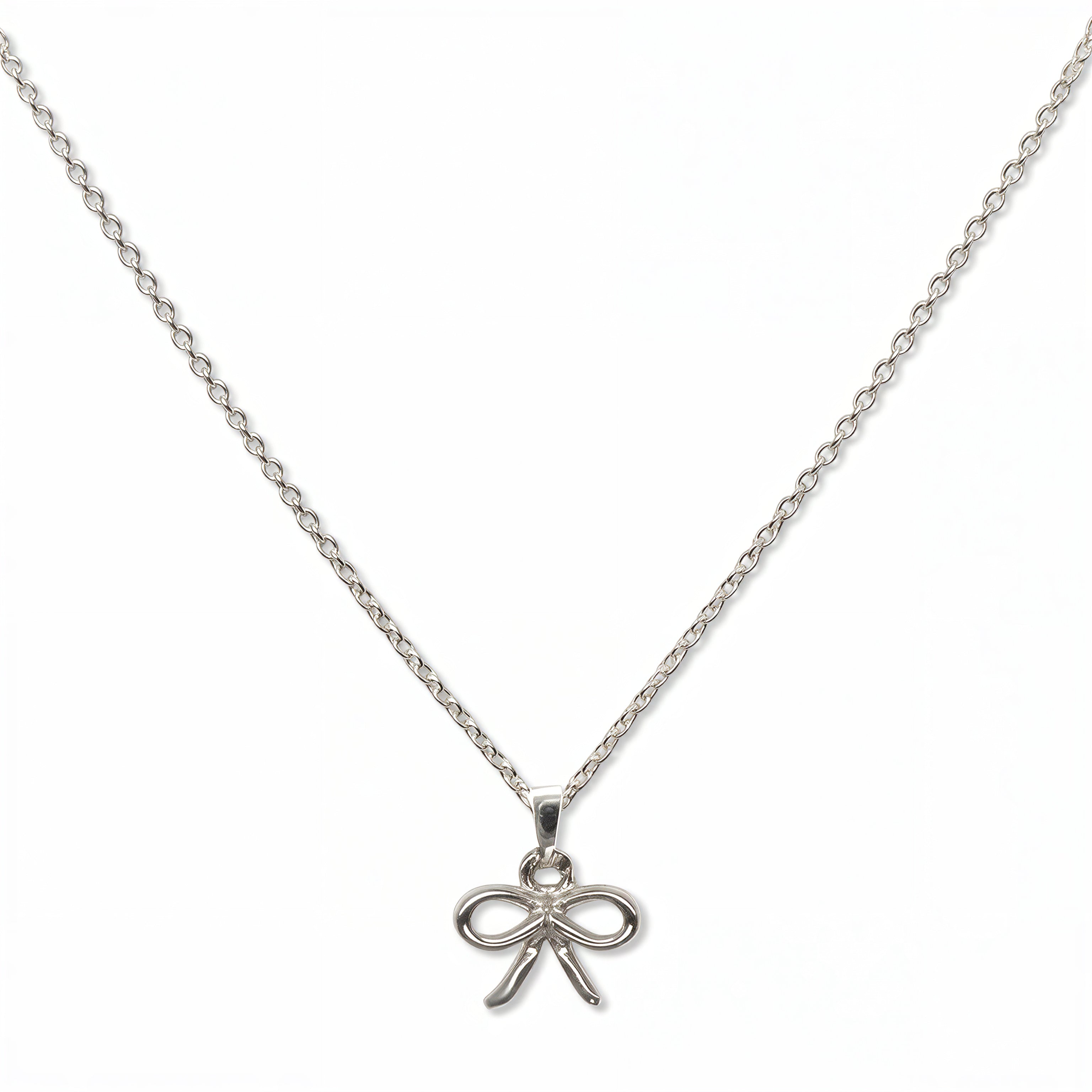 A Skōsh Kids Ribbon Bow Pendant Necklace by Skōsh Jewelry, featuring a dainty ribbon bow pendant on a fine sterling silver chain, displayed against a white background.