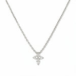 A Skōsh Kids Mini Cross Necklace in White Cubic Zirconia by Skōsh Jewelry, featuring a petite cross of clear marquise and round stones on a fine sterling silver chain, displayed against a white background.