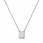 An Engraved Initial Necklace Letter A by Skōsh Jewelry, featuring a small rectangular tag engraved with the letter A on a fine sterling silver chain, displayed against a white background.