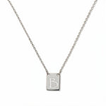 An Engraved Initial Necklace Letter B by Skōsh Jewelry, featuring a small rectangular tag engraved with the letter B on a fine sterling silver chain, displayed against a white background.