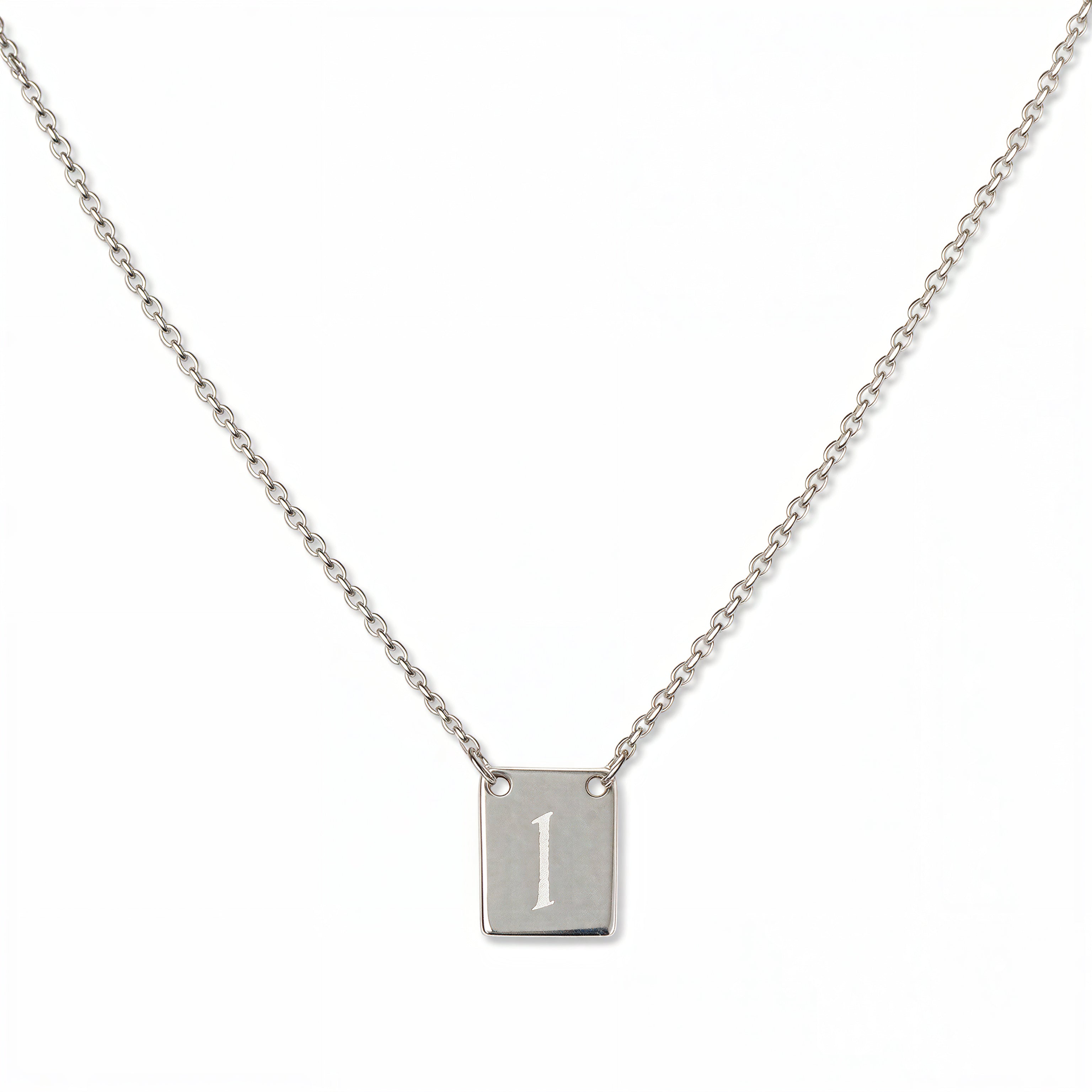 An Engraved Initial Necklace Letter I by Skōsh Jewelry, featuring a small rectangular tag engraved with the letter I on a fine sterling silver chain, displayed against a white background.