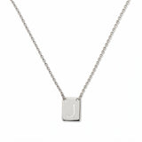 An Engraved Initial Necklace Letter J by Skōsh Jewelry, featuring a small rectangular tag engraved with the letter J on a fine sterling silver chain, displayed against a white background.