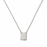 An Engraved Initial Necklace Letter L by Skōsh Jewelry, featuring a small rectangular tag engraved with the letter L on a fine sterling silver chain, displayed against a white background.