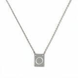 An Engraved Initial Necklace Letter O by Skōsh Jewelry, featuring a small rectangular tag engraved with the letter O on a fine sterling silver chain, displayed against a white background.