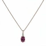 A Skōsh Kids February Birthstone Oval Amethyst Cubic Zirconia Necklace by Skōsh Jewelry, featuring an oval faceted purple stone in a prong setting on a fine sterling silver chain, displayed against a white background.