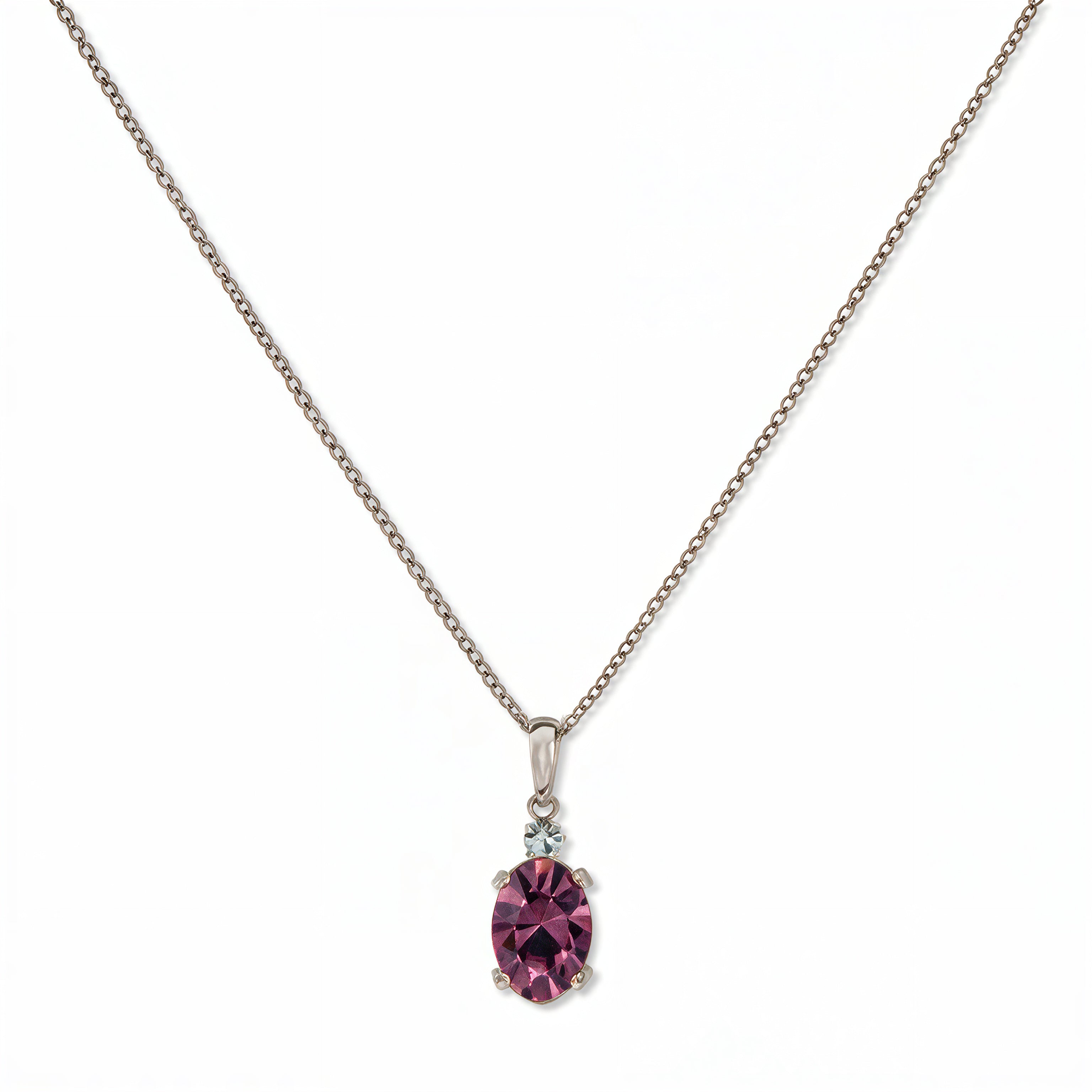 A Skōsh Kids February Birthstone Oval Amethyst Cubic Zirconia Necklace by Skōsh Jewelry, featuring an oval faceted purple stone in a prong setting on a fine sterling silver chain, displayed against a white background.