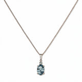 A Skōsh Kids March Birthstone Oval Light Sapphire Cubic Zirconia Necklace by Skōsh Jewelry, featuring an oval faceted light blue stone in a prong setting on a fine sterling silver chain, displayed against a white background.
