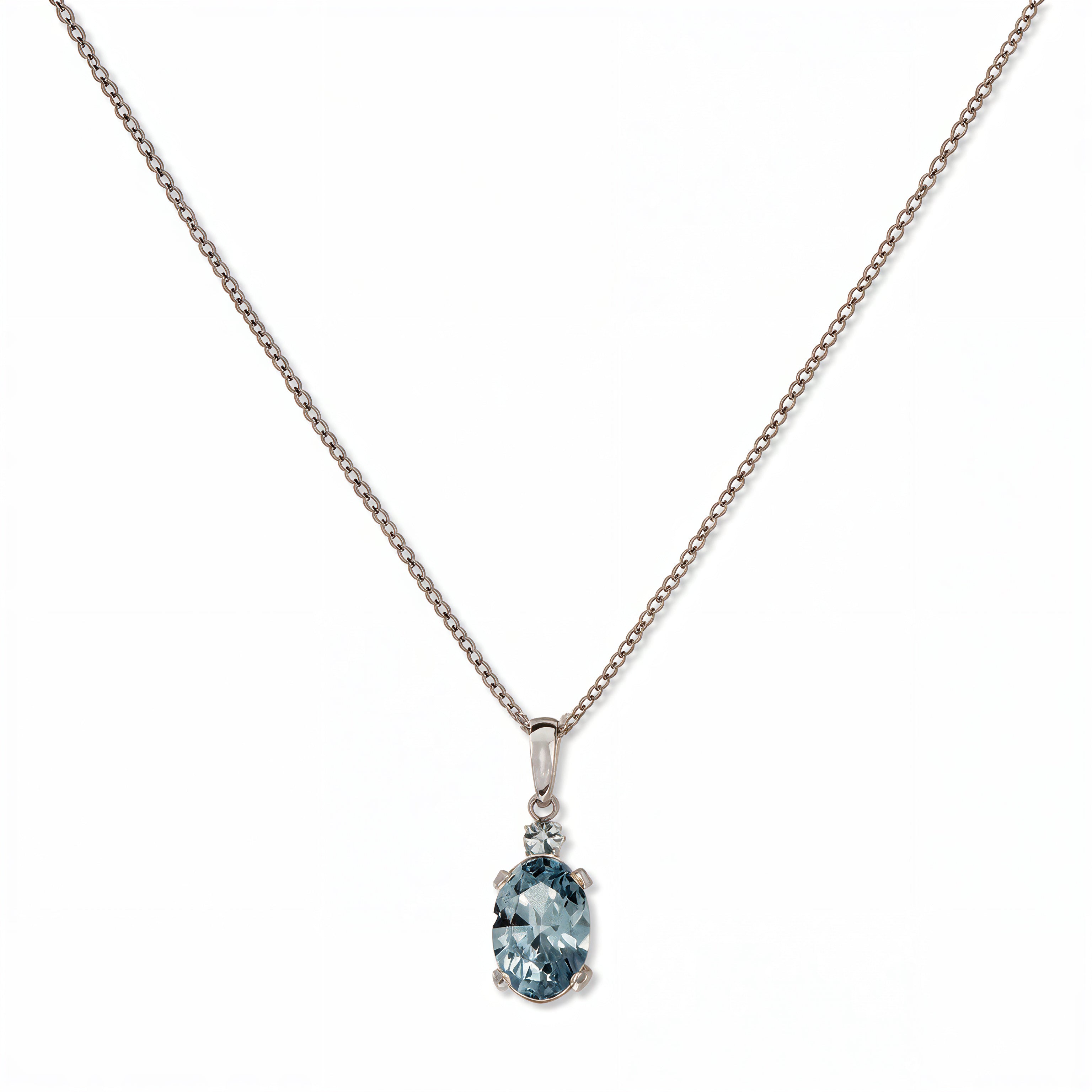 A Skōsh Kids March Birthstone Oval Light Sapphire Cubic Zirconia Necklace by Skōsh Jewelry, featuring an oval faceted light blue stone in a prong setting on a fine sterling silver chain, displayed against a white background.