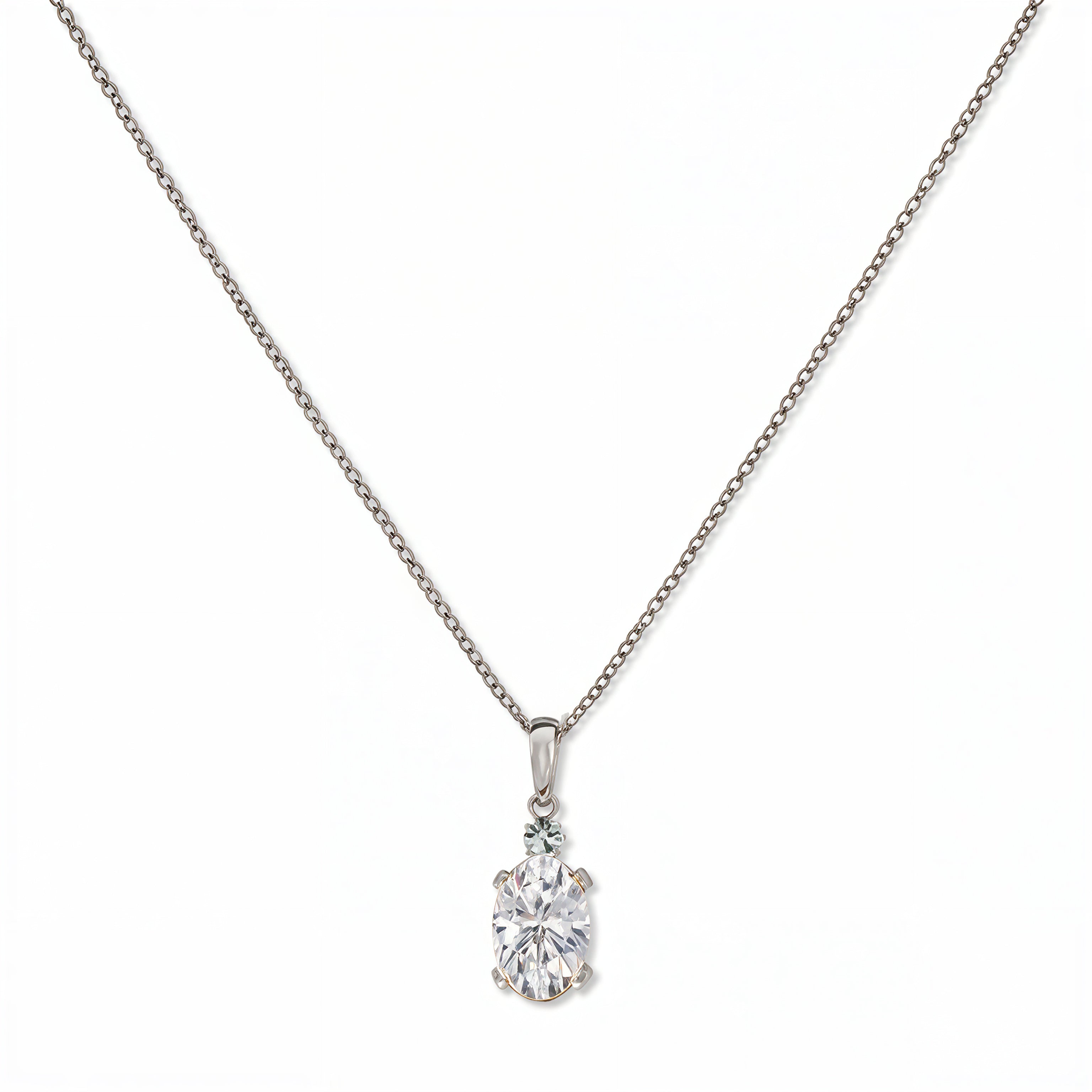 A Skōsh Kids April Birthstone Oval White Cubic Zirconia Necklace by Skōsh Jewelry, featuring an oval faceted clear stone in a prong setting on a fine sterling silver chain, displayed against a white background.