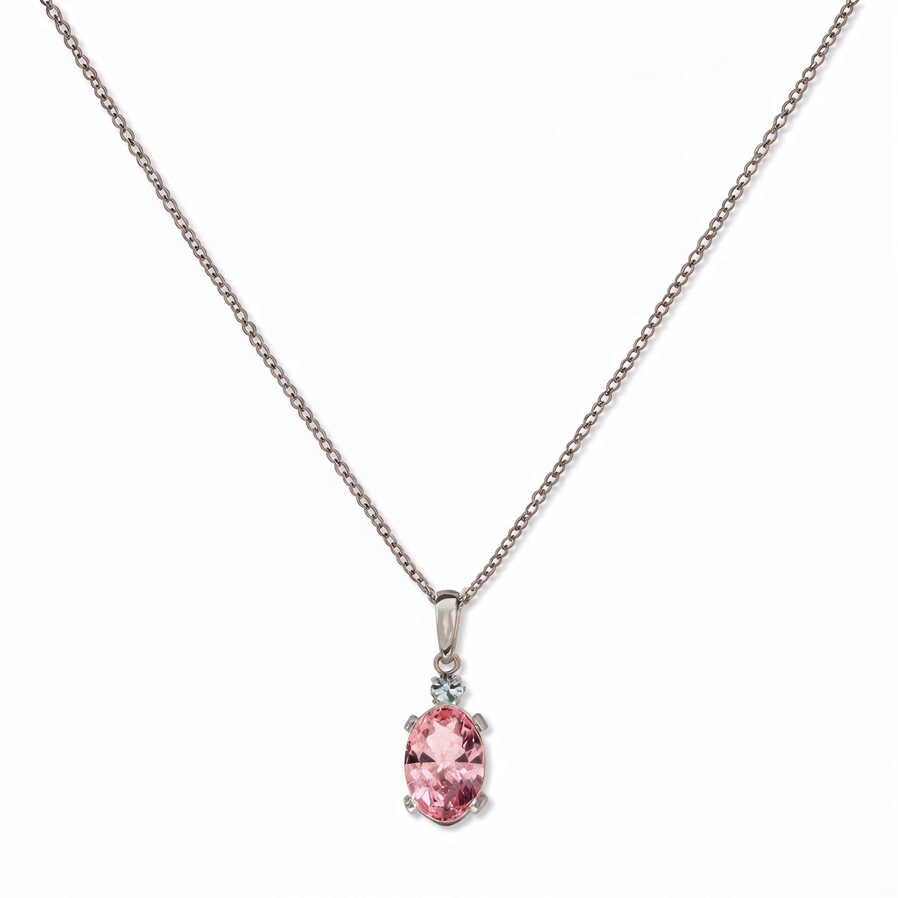 A Skōsh Kids October Birthstone Oval Pink Cubic Zirconia Necklace by Skōsh Jewelry, featuring an oval faceted pink stone in a prong setting on a fine sterling silver chain, displayed against a white background.