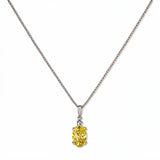 A Skōsh Kids November Birthstone Oval Citrine Cubic Zirconia Necklace by Skōsh Jewelry, featuring an oval faceted yellow stone in a prong setting on a fine sterling silver chain, displayed against a white background.