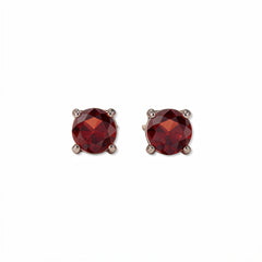 A pair of January Birthstone Round Garnet Cubic Zirconia Stud Earrings by Skōsh Jewelry, featuring faceted deep red round stones in a four-prong sterling silver setting, displayed against a white background.