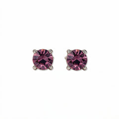 A pair of February Birthstone Round Amethyst Cubic Zirconia Stud Earrings by Skōsh Jewelry, featuring faceted purple round stones in a four-prong sterling silver setting, displayed against a white background.