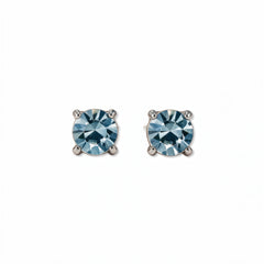 A pair of March Birthstone Round Light Sapphire Cubic Zirconia Stud Earrings by Skōsh Jewelry, featuring faceted light blue round stones in a four-prong sterling silver setting, displayed against a white background.