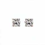 A pair of April Birthstone Round White Cubic Zirconia Stud Earrings by Skōsh Jewelry, featuring faceted clear round stones in a four-prong sterling silver setting, displayed against a white background.