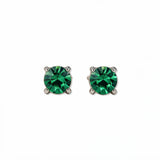 A pair of May Birthstone Round Emerald Cubic Zirconia Stud Earrings by Skōsh Jewelry, featuring faceted green round stones in a four-prong sterling silver setting, displayed against a white background.
