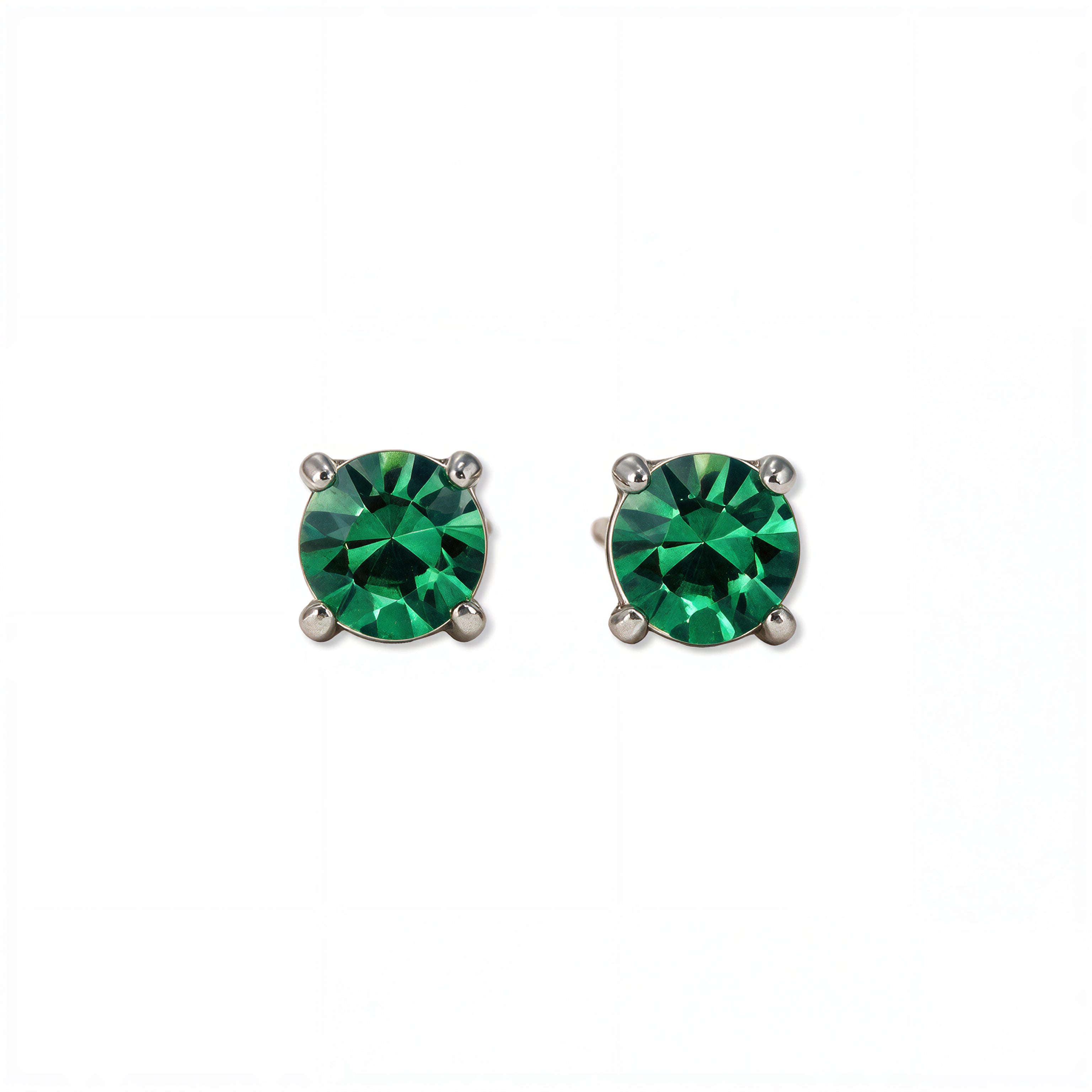 A pair of May Birthstone Round Emerald Cubic Zirconia Stud Earrings by Skōsh Jewelry, featuring faceted green round stones in a four-prong sterling silver setting, displayed against a white background.