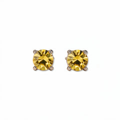 A pair of November Birthstone Round Citrine Cubic Zirconia Stud Earrings by Skōsh Jewelry, featuring faceted yellow round stones in a four-prong sterling silver setting, displayed against a white background.