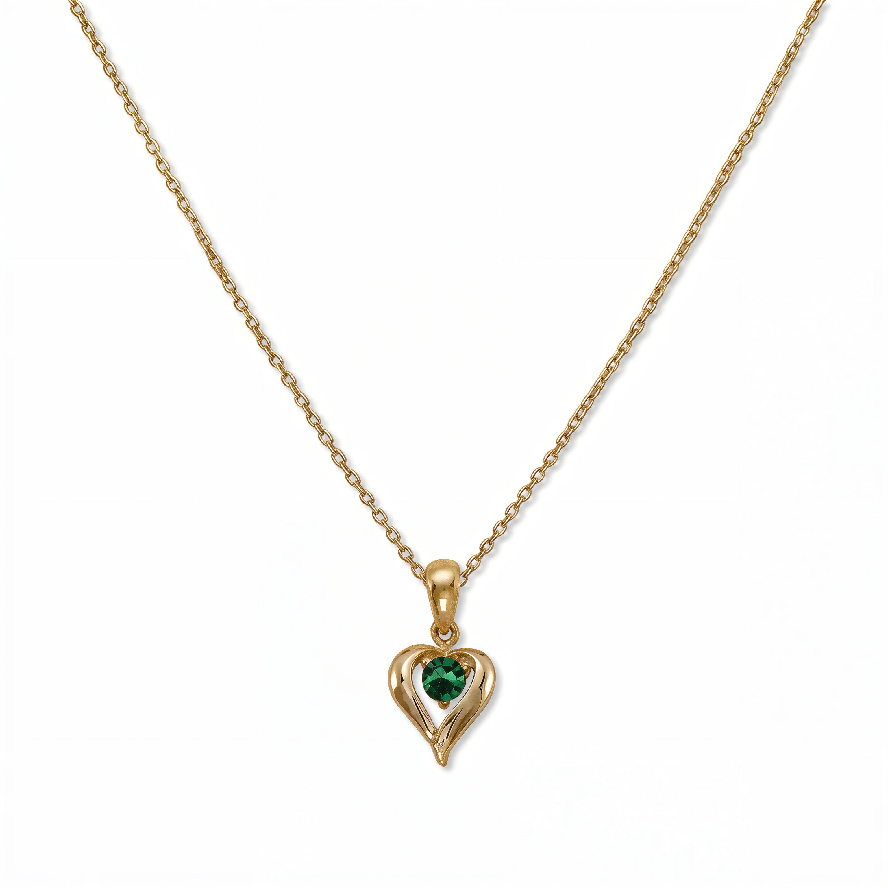 A May Birthstone Emerald Cubic Zirconia Heart Necklace by Skōsh Jewelry, featuring a heart-shaped green stone framed in a sculpted gold heart pendant on a fine chain, displayed against a white background.