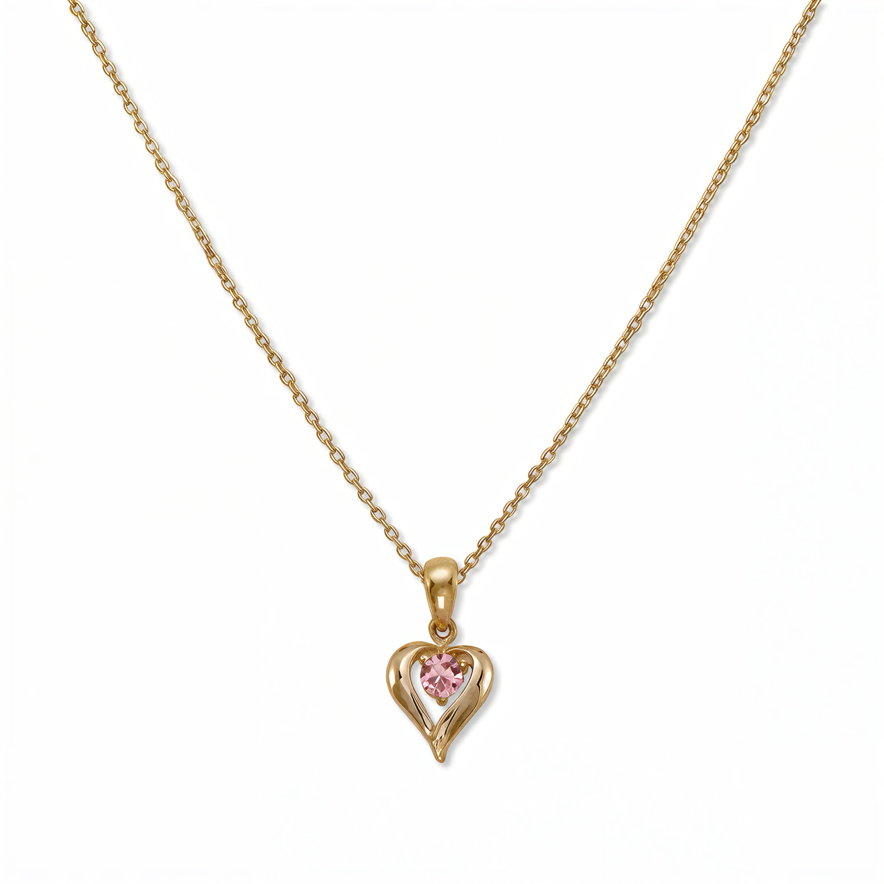 An October Birthstone Pink Cubic Zirconia Heart Necklace by Skōsh Jewelry, featuring a heart-shaped pink stone framed in a sculpted gold heart pendant on a fine chain, displayed against a white background.