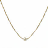A Skōsh Kids "I'm One" Petite Freshwater Pearl Necklace by Skōsh Jewelry, featuring one small white freshwater pearl along a fine gold chain, displayed against a white background.