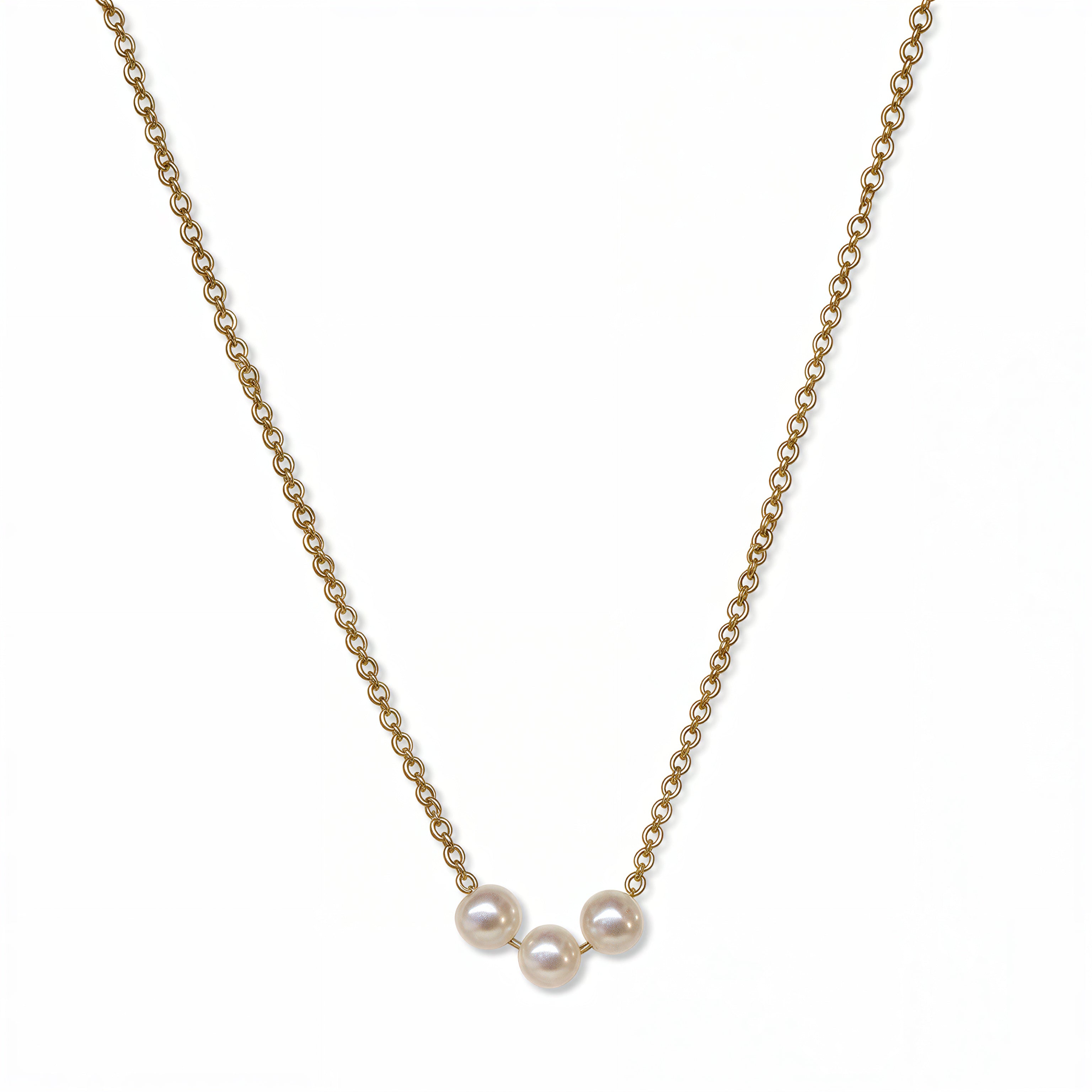 A Skōsh Kids "I'm Three" Petite Freshwater Pearl Necklace by Skōsh Jewelry, featuring three small white freshwater pearls along a fine gold chain, displayed against a white background.