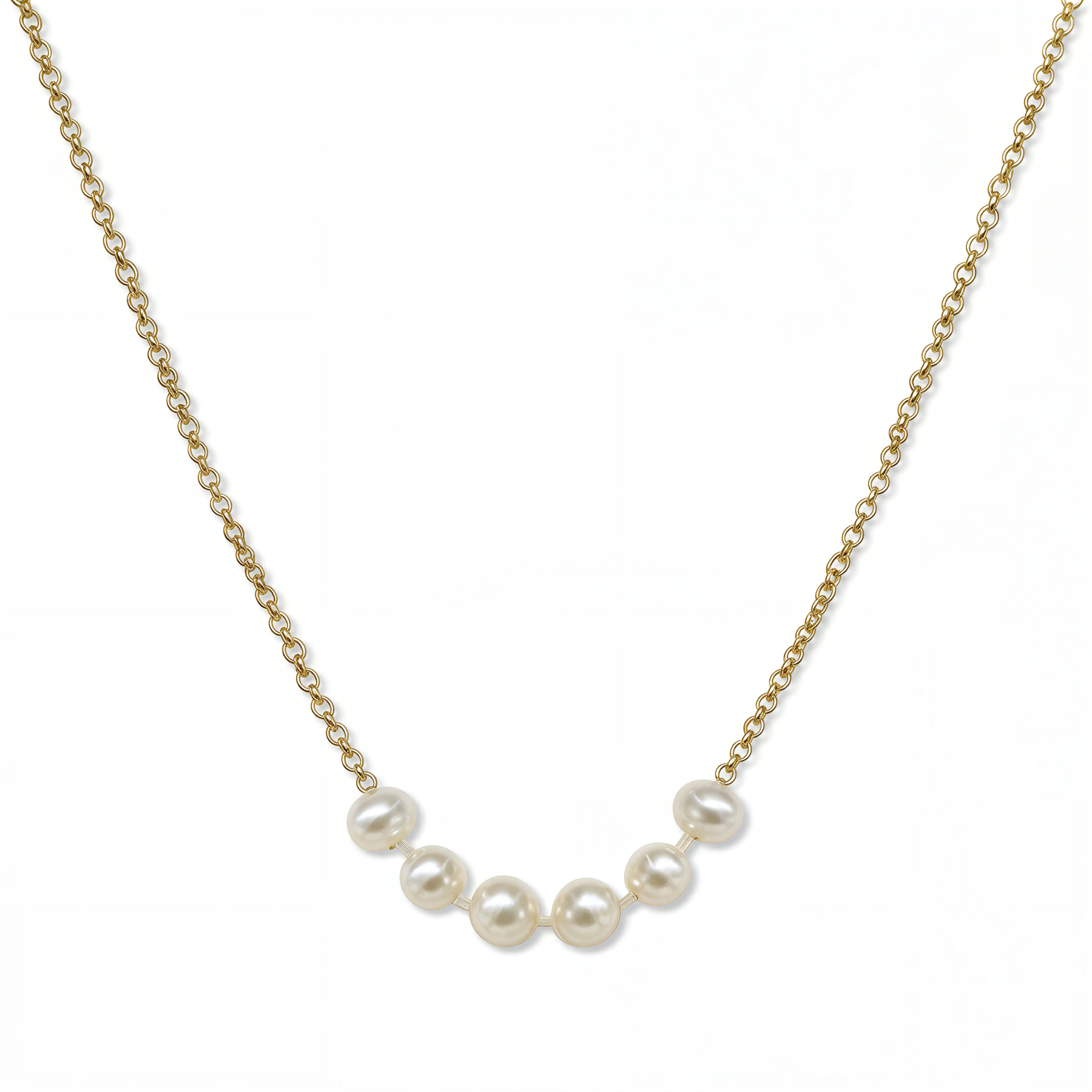 A Skōsh Kids "I'm Six" Petite Freshwater Pearl Necklace by Skōsh Jewelry, featuring six small white freshwater pearls along a fine gold chain, displayed against a white background.
