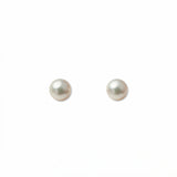 A pair of Freshwater Cultured Pearl 4mm Stud Earrings by Skōsh Jewelry, featuring round, lustrous white freshwater pearls on sterling silver post backs, displayed against a white background.