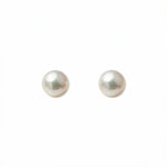A pair of Freshwater Cultured Pearl 6mm Stud Earrings by Skōsh Jewelry, featuring round, lustrous white freshwater pearls on sterling silver post backs, displayed against a white background.